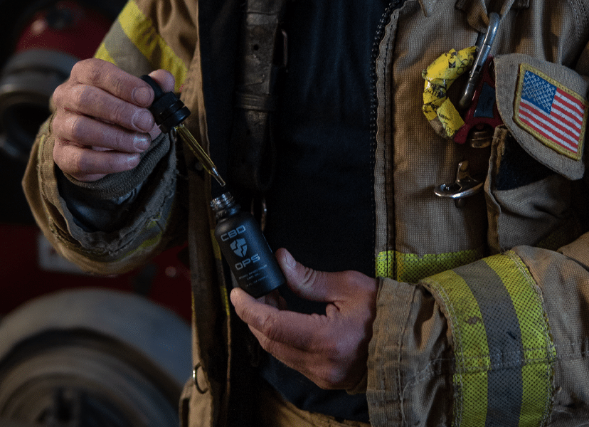 Firefighter taking CBDOps CBD tincture oil created to provide CBD for first responders.