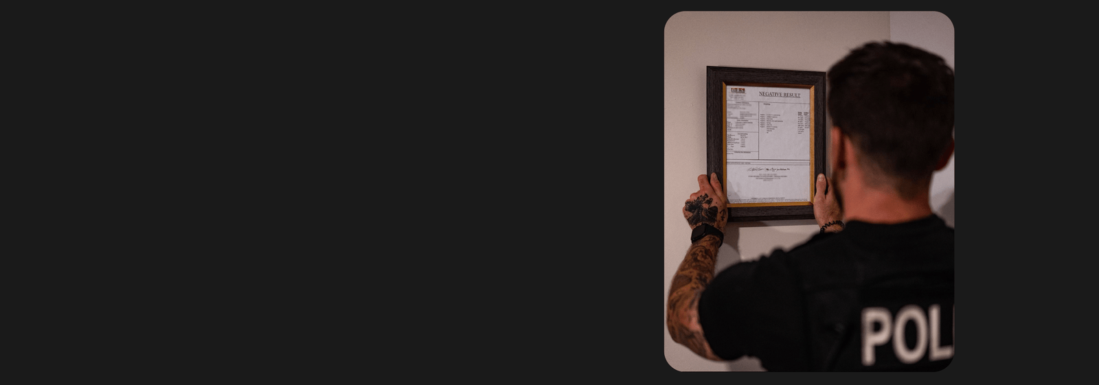 CBDOps founder and police officer hanging up his negative drug test after using CBDOps THC-free products.