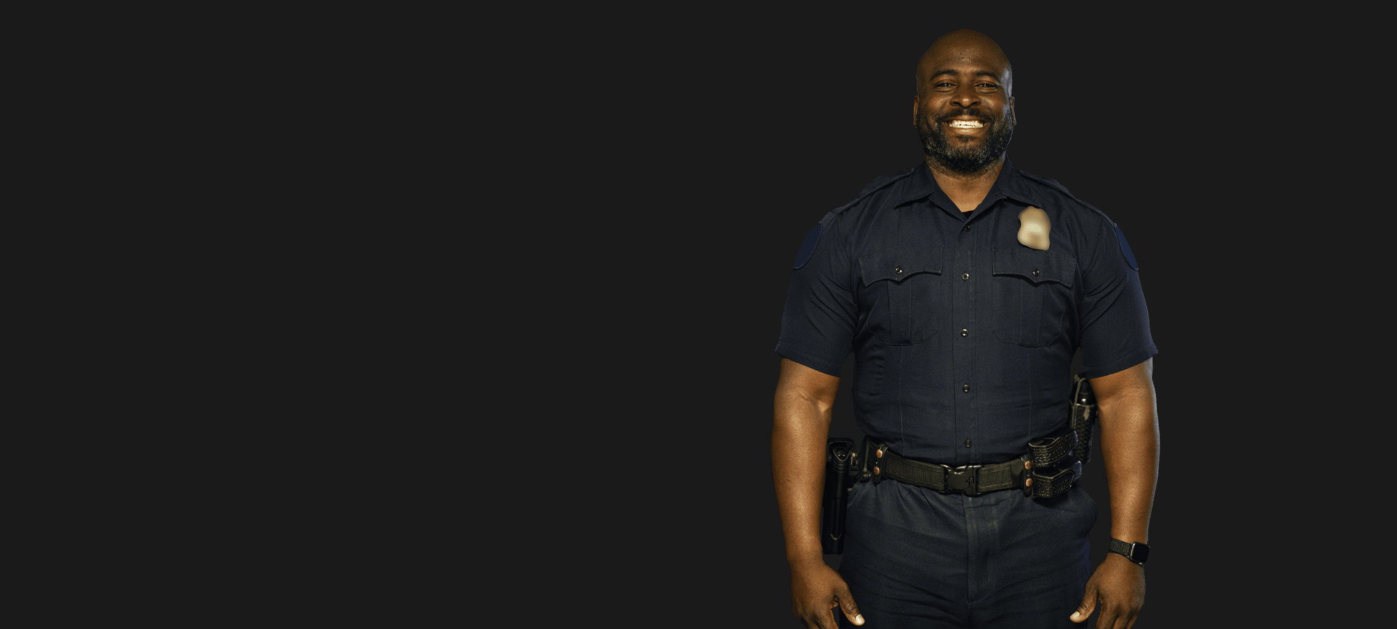 Police officer smiling because he finally found a company that provides CBD for first responders. 