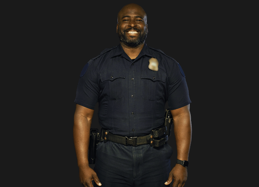Police officer smiling because he finally found a company that provides CBD for first responders. 